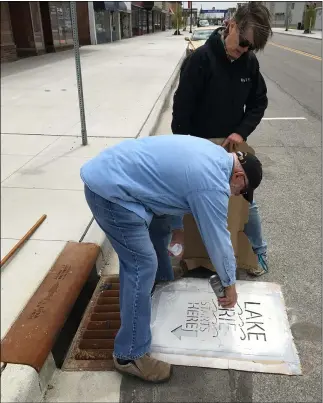  ?? Get involved: Volunteers clean up the Black River waterway and shore areas. Join in at FACEBOOK.COM/LOCOYAKS/. RICHARD PAYERCHIN — THE MORNING JOURNAL ?? Volunteers Brian and Karen Frederick use paint and a stencil to remind walkers and drivers that “Lake Erie Starts Here,” May 5on Broadway Avenue in Lorain.