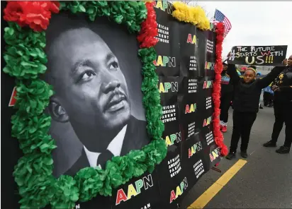  ?? PHOTOS BY CHRIS RILEY — TIMES-HERALD ?? Saniyah Elliott, 8, carries a sign as she walks with the African American Parent Alliance during the Martin Luther King Junior March in Vallejo on Monday.