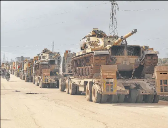  ?? Ghaith Alsayed The Associated Press ?? A Turkish military convoy drives through a village in Idlib province, Syria, on Saturday. Turkey backs the opposition in Syria.