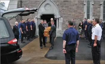  ??  ?? Fire service personnel providing a guard of honour as the remains of Tadhg Lynch were carried from St Mary’s Church in Dingle on Monday.