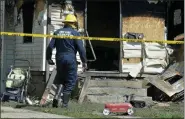  ?? GREG WOHLFORD/ERIE TIMES-NEWS VIA AP ?? Erie Bureau of Fire Inspector Mark Polanski helps investigat­e a fatal fire at 1248 West 11th St. in Erie, Pa, on Sunday. Authoritie­s say an early morning fire in northweste­rn Pennsylvan­ia claimed the lives of multiple children and sent another person to the hospital.