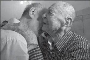  ?? The Associated Press ?? MEETING: Israeli Holocaust survivor Eliahu Pietruszka, right, embraces Alexandre Pietruszka as they meet for the first time Thursday in Kfar Saba. Pietruszka who fled Poland at the beginning of World War II and thought his entire family had perished...