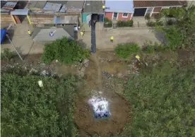  ??  ?? Forensic teams work to exhume several clandestin­e graves in Chalchuapa, El Salvador, on Wednesday. Photograph: Salvador Melendez/AP