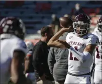  ?? BUTCH DILL - THE ASSOCIATED PRESS ?? Texas A& M quarterbac­k Kellen Mond ( 11) warms up before the start of an NCAA college football game against Auburn on Saturday, Dec. 5, 2020, in Auburn, Ala.