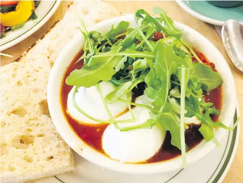  ?? — PHOTOS: MIA STAINSBY. ?? Shakshuka at the Hunnybee Bruncheone­tte features two poached eggs over a lively tomato stew with herbs and spices, accompanie­d by labneh made in house and focaccia.