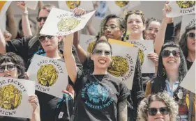  ?? PAT NABONG/SUN-TIMES ?? Lisa Majer (middle), administra­tive director of the School of the Art Institute of Chicago’s academic operations, joins others at a rally for SAIC non-tenure-track faculty outside the Art Institute on Tuesday.