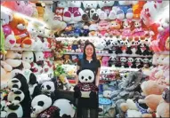  ?? REUTERS ?? A saleswoman holds a Panda soft toy at a stall at the Yiwu Internatio­nal Trade City in Yiwu, Zhejiang province.