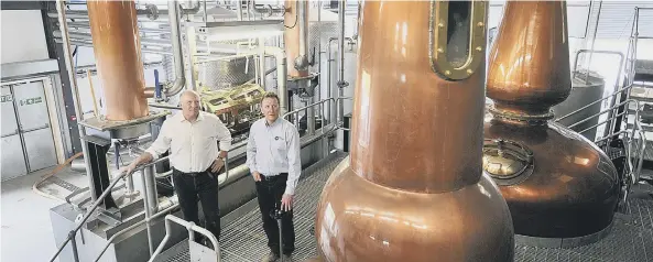  ??  ?? Co-business owner Tom Mellor and David Thompson in the processing area of the distillery. By Richard Ponter 171122e