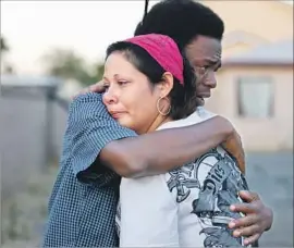  ?? Francine Orr Los Angeles Times ?? ROBERTA ALCANTAR is hugged by a friend of her late son, Armando, 17. “He was a very loving person,” she said of the teenager.