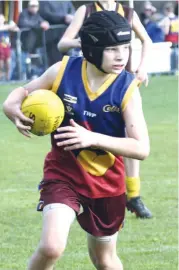  ??  ?? Colts player Brock Hamilton looks for a passing option during the under 12 match.