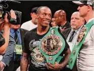  ?? Ronald Cortes/Getty Images ?? O'Shaquie Foster smiles at trainer Bobby Benton after beating Rey Vargas on Saturday night.