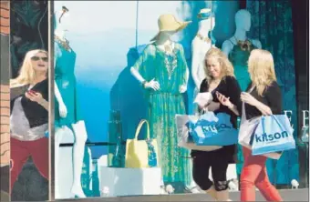  ?? Mel Melcon
Los Angeles Times ?? SHOPPERS MAKE THEIR WAY past the Hale Bob store on Robertson Boulevard in Los Angeles. Experts say consumers are gravitatin­g toward bright hues that are saturating summer fashions.