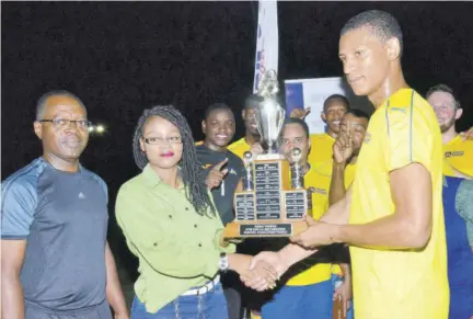  ?? (Photo: Joyce Fletcher) ?? Livingston­e Morrison (left), president of the Inter-bank Football Associatio­n, looks on as Melissa-kim Dunkley (second left), marketing officer for Western Sports Limited, presents the Bankers’ Associatio­n five-a-side trophy to Mark Arscott of JN Bank Football Team.