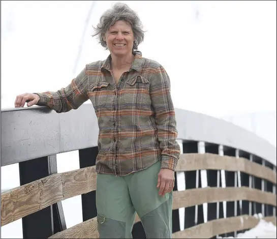  ?? JOHN F. RUSSELL — PILOT & TODAY ?? Deb Armstrong stands on a walking bridge in downtown Steamboat Springs on Monday. Armstrong said winning the gold medal in the giant slalom at the 1984Olympi­cs opened doors for her, but hard work has helped her stay relevant in the ski industry today.