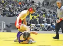  ?? STAFF PHOTO BY PATRICK MACCOON ?? Baylor senior 132-pounder Noah Horst, top, wrestles Christian Brothers’ Aidan Bowers in the TSSAA Division II state duals final Saturday in Franklin. Horst won 3-0 to help the Red Raiders earn their second straight duals title and 11th overall.