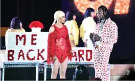  ??  ?? Atage crashing: Cardi B is presented a ‘Take Me Back’ card onstage by her husband Offset. Photograph: Scott Dudelson/Getty Images