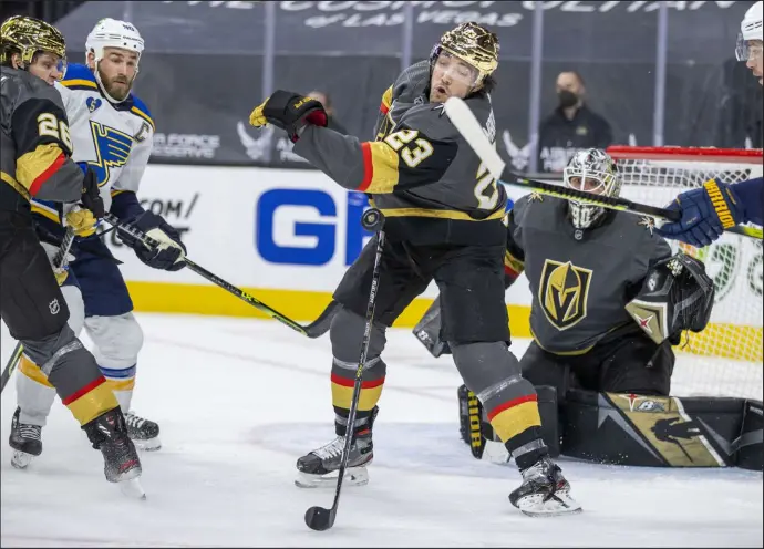  ?? L.E. Baskow Las Vegas Review-journal @Left_eye_images ?? Golden Knights defenseman Alec Martinez (23) slaps a puck down against the St. Louis Blues. Martinez led the NHL in blocked shots in 2020-21.