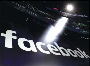  ?? ASSOCIATED PRESS ?? In this March 29, 2018, file photo the logo for Facebook appears on screens at the Nasdaq MarketSite in New York’s Times Square.