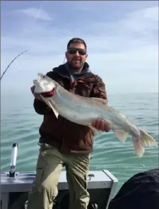  ??  ?? Mike Hallas of Jefferson Hills caught and released a lake trout estimated to weigh 15 pounds in Lake Erie off North East, Pa., in April 2018.