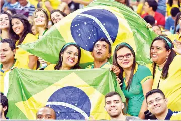  ?? — AFP photo ?? This file photo taken on October 14, 2015 shows supporters of Brazil waiting for the start of the Russia 2018 FIFA World Cup South American Qualifiers football match between Brazil and Venezuela, at the Estadio Castelao stadium in Fortaleza, Brazil.