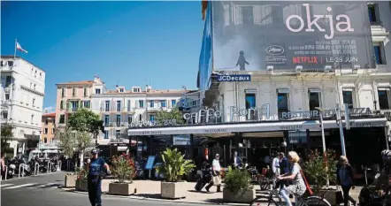  ?? — Reuters ?? Content hub: A poster for the Netflix movie ‘Okja’ in competitio­n at the Cannes Film Festival is displayed on the Croisette. MyIX deal with Netflix will pave the way for Malaysia to become a regional content hub.