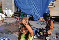  ?? John Locher / Associated Press ?? Mary-louise Lacobon, 6, holds a squirrel she and her family helped after it was injured in the storm in Dulac, La.