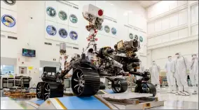  ?? AP FILE PHOTO ?? In this Dec. 17, 2019 photo made available by NASA, engineers watch the first driving test for the Mars 2020 rover, later named “Perseveran­ce,” in a clean room at the Jet Propulsion Laboratory in Pasadena, Ca.