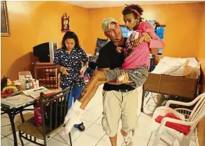  ?? — Photos: Tns ?? Linda being carried around by her father Fernando Izquierdo at her home in Homestead, Florida, the united States. Linda fell into a coma following complicati­ons after undergoing a breast augmentati­on procedure. ( right) ‘ My daughter is like a baby...