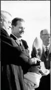  ?? (Arkansas Democrat-Gazette file photos) ?? LEFT Former Arkansas Athletic Director and football Coach Frank Broyles (center) receives the championsh­ip trophy during the 1964 season from the Football Writers Associatio­n of America. The Razorbacks finished 11-0 that season but were ranked second behind Alabama (10-1) in the final Associated Press poll, which was taken before the bowl games. The next season, the final AP poll was released after the bowl games for the first time. These are among the key college football moments Arkansas has been a part of over the years that led to changes.