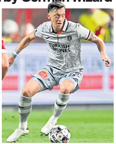  ?? ?? Mesut Ozil in action for Istanbul Besaksehir and (below) Gary Mackay-Steven on his European debut for Dundee United against Slask Wroclaw 11 years ago