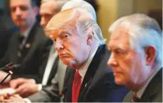  ?? AP ?? US President Donald Trump (centre) listens as Iraqi Prime Minister Haider Al Abadi speaks during a meeting in the Cabinet Room of the White House on Monday.