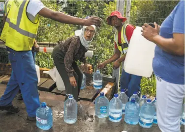  ?? Joao Silva / New York Times ?? City residents collect water from a spring. A three-year drought is considered the worst in over a century.