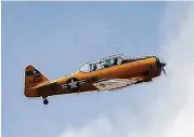  ??  ?? A T-6 Texan, part of the Lone Star Flight Museum, takes one of its last flights over Galveston on Saturday.