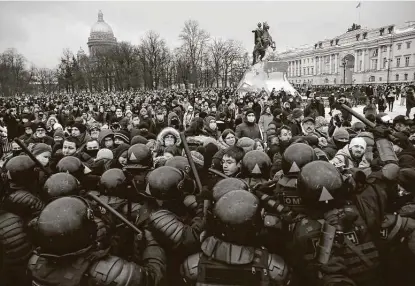  ?? Dmitri Lovetsky / Associated Press ?? Demonstrat­ors clash with police during a protest in St. Petersburg, Russia, against the jailing of opposition leader Alexei Navalny, an activist well known nationally for his reports on corruption under President Vladimir Putin’s government.