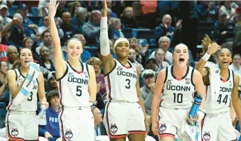  ?? CLOE POISSON/SPECIAL TO THE COURANT ?? The Uconn bench reacts to a three-point shot by Ice Brady on Thursday.