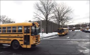  ??  ?? Buses drop off students at Turn of River Middle School in Stamford on Tuesday.