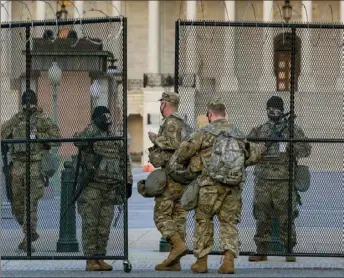  ?? J. Scott Applewhite/Associated Press ?? National Guard troops keep watch at the U.S. Capitol in Washington early Thursday amid intelligen­ce warnings that there was a “possible plot” by a group of militia extremists to take control of the Capitol on March 4 to remove Democrats from power.