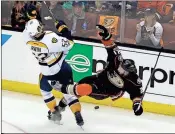  ?? Chris Carlson / The Associated Press ?? Nashville’s Matt Irwin (left) collides with Anaheim’s Chris Wagner as they battle for the puck Sunday in Anaheim, Calif.