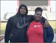  ?? Submitted photo ?? Javion Cohen (left), an offensive lineman prospect from Phenix City, Ala., looks up to his mother Philecia Fuller, who works two jobs to provide for Cohen, his two sisters, niece and two nephews. Cohen is expected to visit Arkansas on March 9.