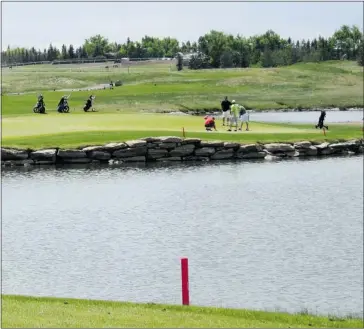  ?? John Down, Calgary Herald ?? The Canal’s signature hole is the 169-yard 15th, which features a two-tiered green camped on one side of a large pond.