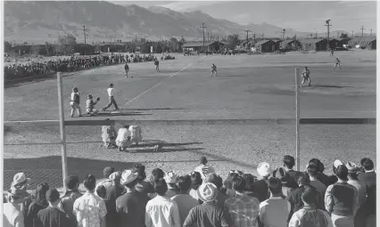  ?? ?? A baseball game takes place at Manzanar, an internment camp where Japanese Americans were forcibly relocated during World War II in the California desert.