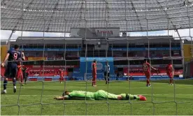  ?? Photograph: Matthias Hangst/Getty Images Europe/dpa ?? Leverkusen’s Lukas Hradecky is left sprawled on the ground after Leon Goretzka’s goal made it 2-1 to Bayern Munich.