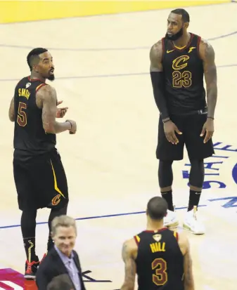  ?? Scott Strazzante / The Chronicle ?? LeBron James (23) looks at teammate J.R. Smith after Smith’s gaffe at the end of regulation in Game 1. The sequence began with George Hill (3) missing a free throw.