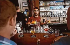  ?? Michael Macor/The Chronicle ?? Bryce Bishari serves patrons at Monk’s Kettle in the Mission District in 2017. The bar and restaurant will close in June before a new location opens in Oakland.