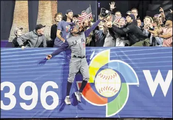  ?? GREGORY BULL / ASSOCIATED PRESS ?? U.S. center fielder Adam Jones takes a home run away from the Dominican Republic’s Manny Machado in Saturday’s WBC game in San Diego.