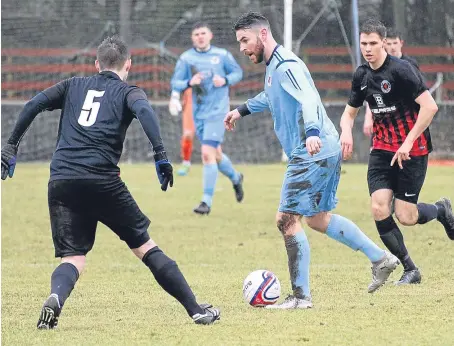  ??  ?? Carnoustie’s leading scorer Ryan Dignan on the ball in the GA Engineerin­g Cup clash with Longside.