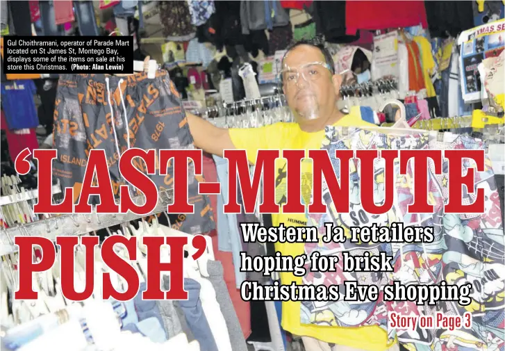  ?? (Photo: Alan Lewin) ?? Gul Choithrama­ni, operator of Parade Mart located on St James St, Montego Bay, displays some of the items on sale at his store this Christmas.