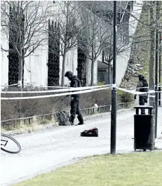  ?? HENRIK MONTGOMERY/TT VIA AP ?? Swedish police search the area outside Varby Gard metro station, in Stockholm, near to where two people were injured by some kind of explosion, on Sunday.