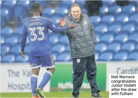  ??  ?? Neil Warnock congratula­tes Junior Hoilett after the draw with Fulham