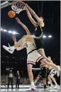  ?? BRYNN ANDERSON – AP ?? Purdue’s Zach Edey dunks over Uconn’s Donovan Clingan during Monday night’s NCAA title game.